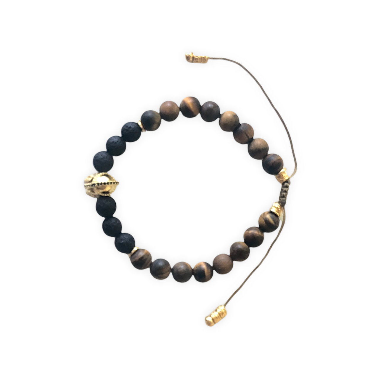 Espectacular pulsera de piedra natural lava y ojo de tigre, cuentas de zamak con baño de oro y un casco de Guerrero con baño de oro que hace que sea ideal para el día a día. Esta pulsera es ajustable lo que la hace perfecta. 