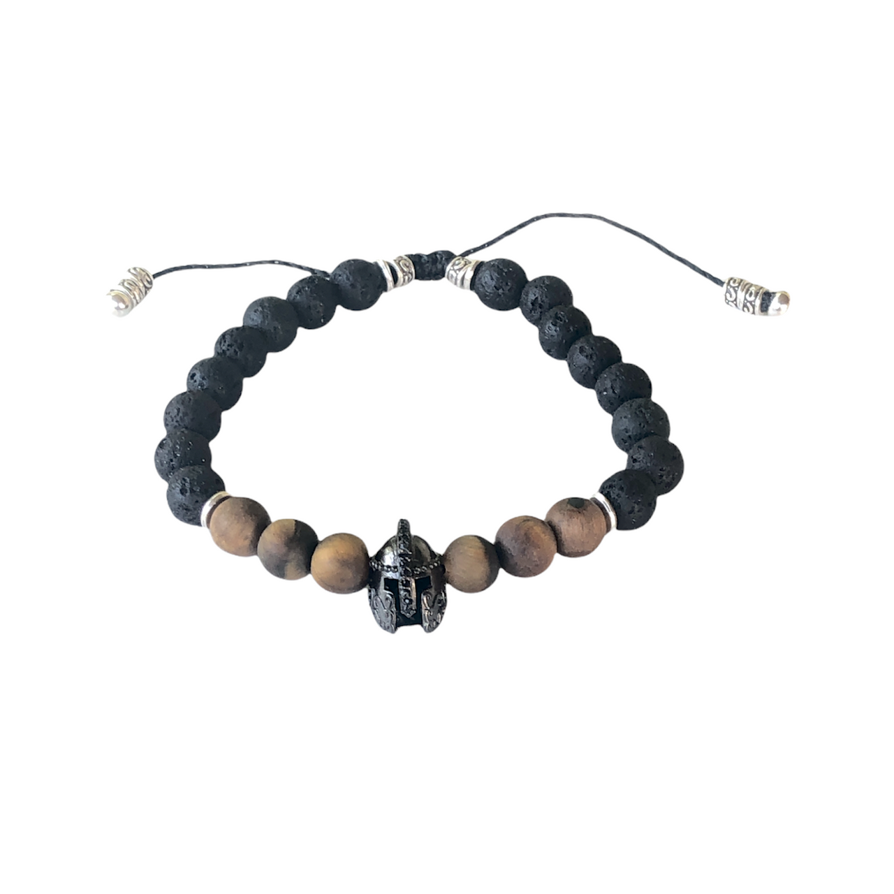 Espectacular pulsera de piedra natural lava y ojo de tigre, cuentas de zamak con baño de plata y un casco de Guerrero con baño de cromo negro que  hace que sea ideal para el día a día. Esta pulsera es ajustable lo que la hace perfecta. Frontal